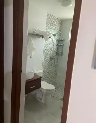 a small bathroom with a toilet and a shower at Paraíso Tropical Juan Dolio in Villas del Mar