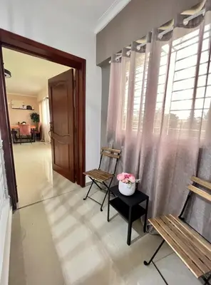 a living room with two chairs and a window at Condominio Emilia in Cancino