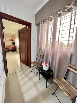 a living room with two chairs and a window at Condominio Emilia in Cancino