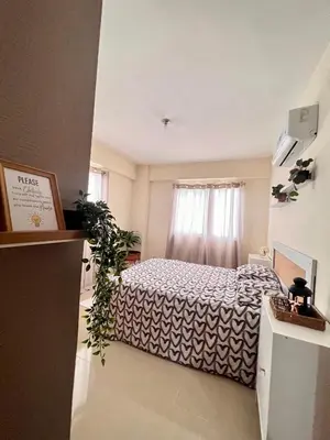 a bedroom with a bed and a window at Condominio Emilia in Cancino
