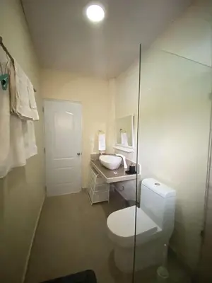 a bathroom with a toilet and a sink at 2BR & 2 WR ocean view Suite at Villa Costa Verde in Playa Cofresi, Puerto Plata, with a pool, big veranda, and a rooftop terrace in San Felipe de Puerto Plata