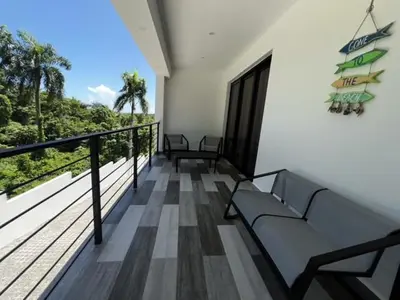 a balcony with benches and a view of the ocean at Villas Montemar - Villa Mar in Las Terrenas