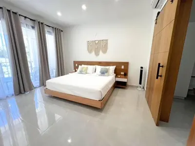 a bedroom with a bed and a large window at Villas Montemar - Villa Mar in Las Terrenas