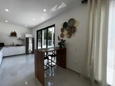 a kitchen with a counter and a table in a room at Villas Montemar - Villa Sol in Las Terrenas