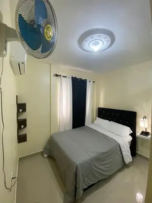 a bedroom with a bed with a fan on the ceiling at Hogar lejos de casa, piscina in San Cristóbal