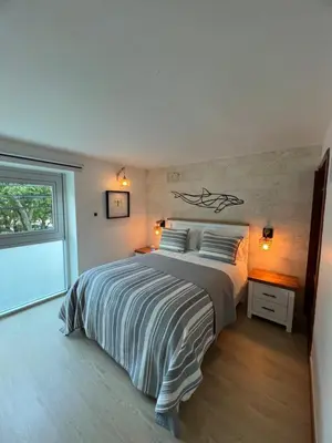 a bedroom with a large bed and a window at Aqua Loft 120 in La Puntica de Juan Dolio