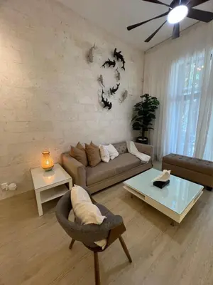 a living room with a couch and a table at Aqua Loft 120 in La Puntica de Juan Dolio