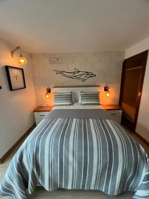 a bedroom with a bed with a whale on the wall at Aqua Loft 120 in La Puntica de Juan Dolio