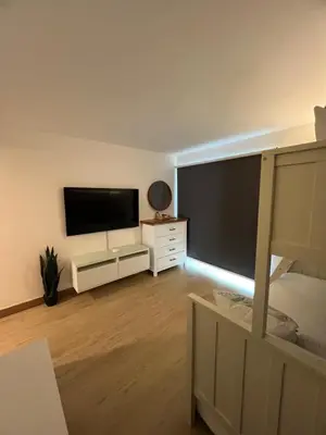 a living room with a large flat screen tv at Aqua Loft 120 in La Puntica de Juan Dolio
