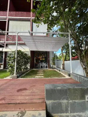 a building with a wooden walkway in front of it at Aqua Loft 120 in La Puntica de Juan Dolio