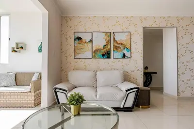 a living room with a couch and a glass table at Luxury Ocean View Condo in Santo Domingo in La Francia