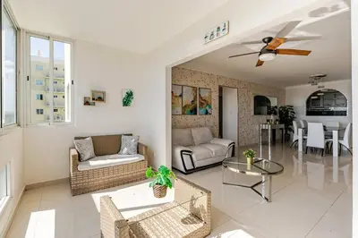 a living room with a couch and a table at Luxury Ocean View Condo in Santo Domingo in La Francia