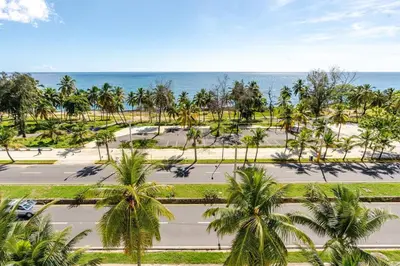 an aerial view of a road with palm trees and the ocean at Luxury Ocean View Condo in Santo Domingo in La Francia
