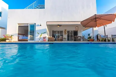 a swimming pool in front of a villa at Villa Ruby Bella in Sosúa