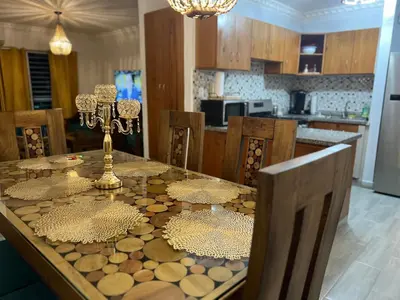 a kitchen with a dining room table with a tableablish at Cozy Retreat 1st Floor in Arenoso
