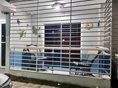 a building with a window with a bunch of shoes at Cozy Retreat 1st Floor in Arenoso