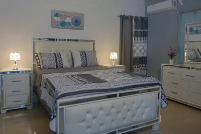 a bedroom with a large bed and a dresser at Casa Ballenas3 SF in Las Terrenas