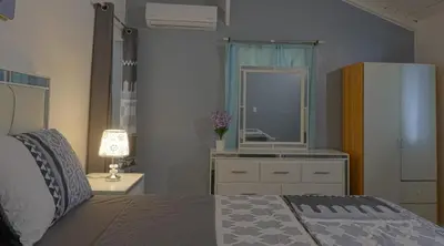 a bedroom with a bed and a sink and a mirror at Casa Ballenas3 SF in Las Terrenas