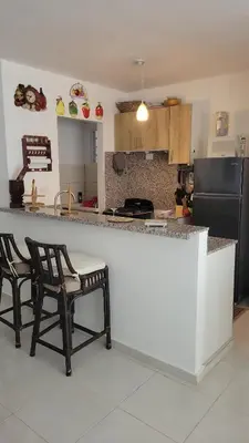 a kitchen with two chairs sitting at a counter at Solo para dos in La Romana