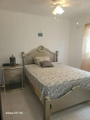 a bedroom with a bed and a side table at Solo para dos in La Romana