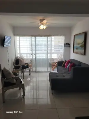 a living room with a couch and chairs and a ceiling fan at Solo para dos in La Romana