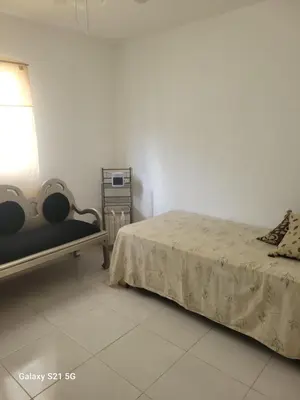 a bedroom with a bed and a table and a lamp at Solo para dos in La Romana