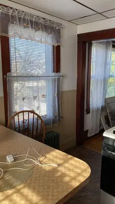 a dining room with a table and a window at Rancho silvestre in Monte Plata