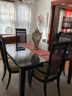 a dining room table and chairs with a vase on it at Rancho silvestre in Monte Plata