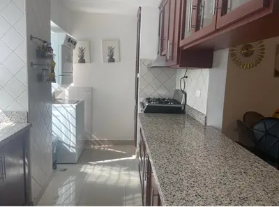 a kitchen with a refrigerator and a counter top at Santuario Tropical at Marino Paradise in La Puntica de Juan Dolio