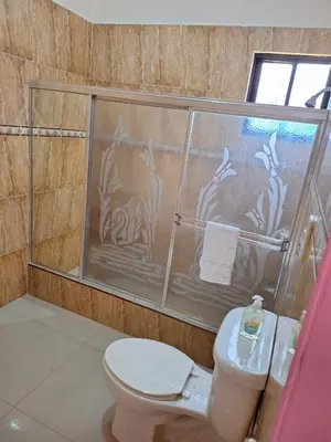 a bathroom with a toilet and a glass shower at Casa Rural con Piscina in Azua de Compostela