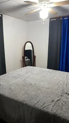 a bedroom with a bed and a mirror and a ceiling at Rancho silvestre in Monte Plata