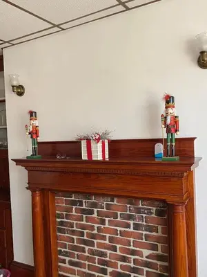 a fireplace with two figurines on top of it at Rancho silvestre in Monte Plata