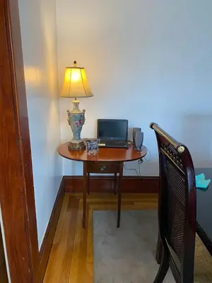 a table with a laptop on it with a lamp on it at Rancho silvestre in Monte Plata