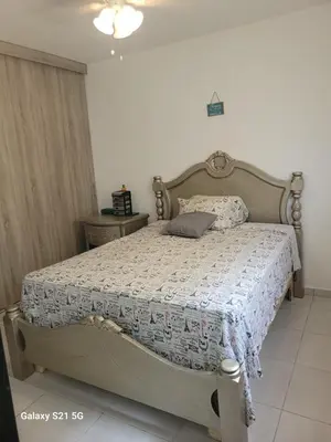 a bedroom with a bed with a quilt on it at Romana Tropical in La Romana