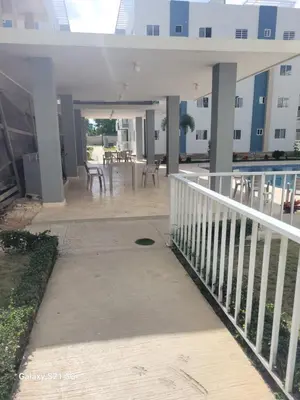 a porch of a building with tables and chairs at Romana Tropical in La Romana
