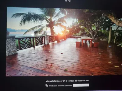 a wooden deck with a bench and a palm tree at Villa Los Corralillos in Cabrera