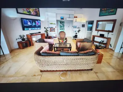 a living room with a couch and a table at Villa Los Corralillos in Cabrera