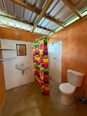 a bathroom with a toilet and a sink at Atabeba in Las Galeras
