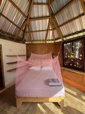 a bedroom with a pink bed in a room at Atabeba in Las Galeras