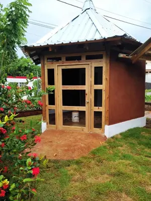 a doghouse with a window in a yard at Atabeba in Las Galeras