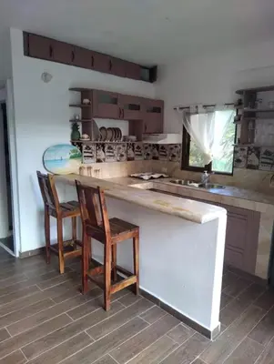 a kitchen with a counter with chairs and a counter top at Casa Mariana in Las Terrenas