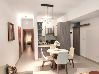 a kitchen and dining room with a table and chairs at Style and Confort Apart Villa Palmera in Santo Domingo