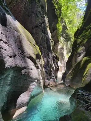 a pool of blue water in a rocky canyon at Hotel-Restaurante Snack Cana in La Ciénaga