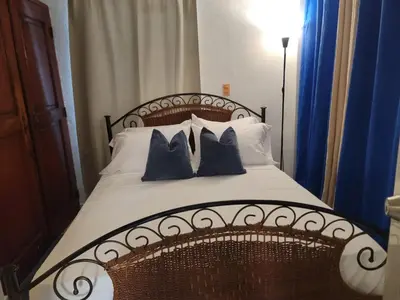 a bedroom with a bed with two pillows on it at Fantastic with Terrace in the colonial zone in Santo Domingo