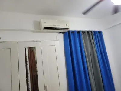 a room with blue curtains and a air conditioner at Fantastic with Terrace in the colonial zone in Santo Domingo