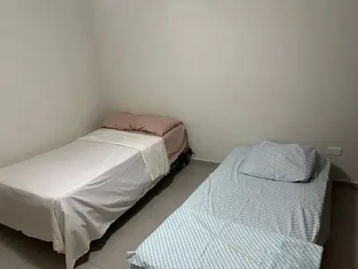 two twin beds in a room with a wall at Apartamento en Arroyo Hondo viejo in Santo Domingo