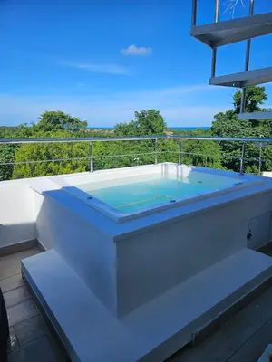 a hot tub on the balcony of a house at Las Terrenas Paradise in Las Terrenas
