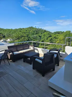 a balcony with couches and chairs on a boat at Las Terrenas Paradise in Las Terrenas