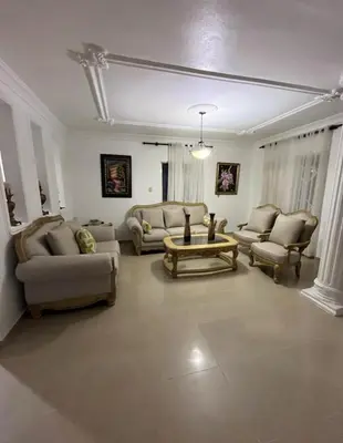 a living room with couches and a coffee table at Encantadora Casa Familiar en Santiago in Santiago de los Caballeros