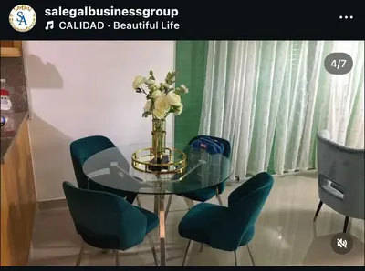 a dining room table with chairs and a vase of flowers at S A Business RENTAL SALE in Juan López